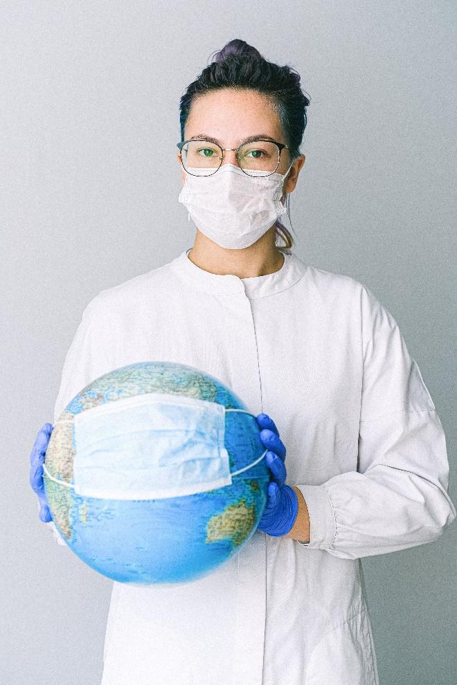 Photo by Anna Shvets: https://www.pexels.com/photo/photo-of-person-wearing-protective-wear-while-holding-globe-4167541/ 